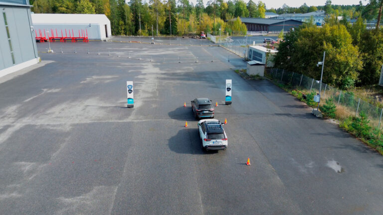 Two Unikie cars parked in a gated area in Kaarina, Finland.