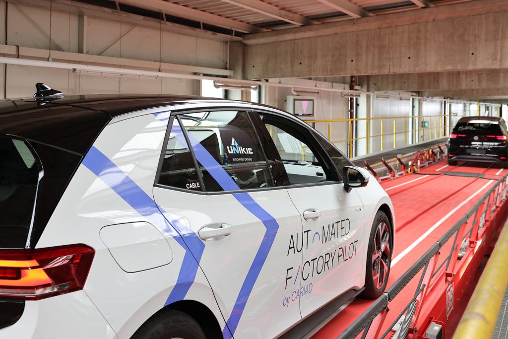 Car driving autonomously onto a train wagon